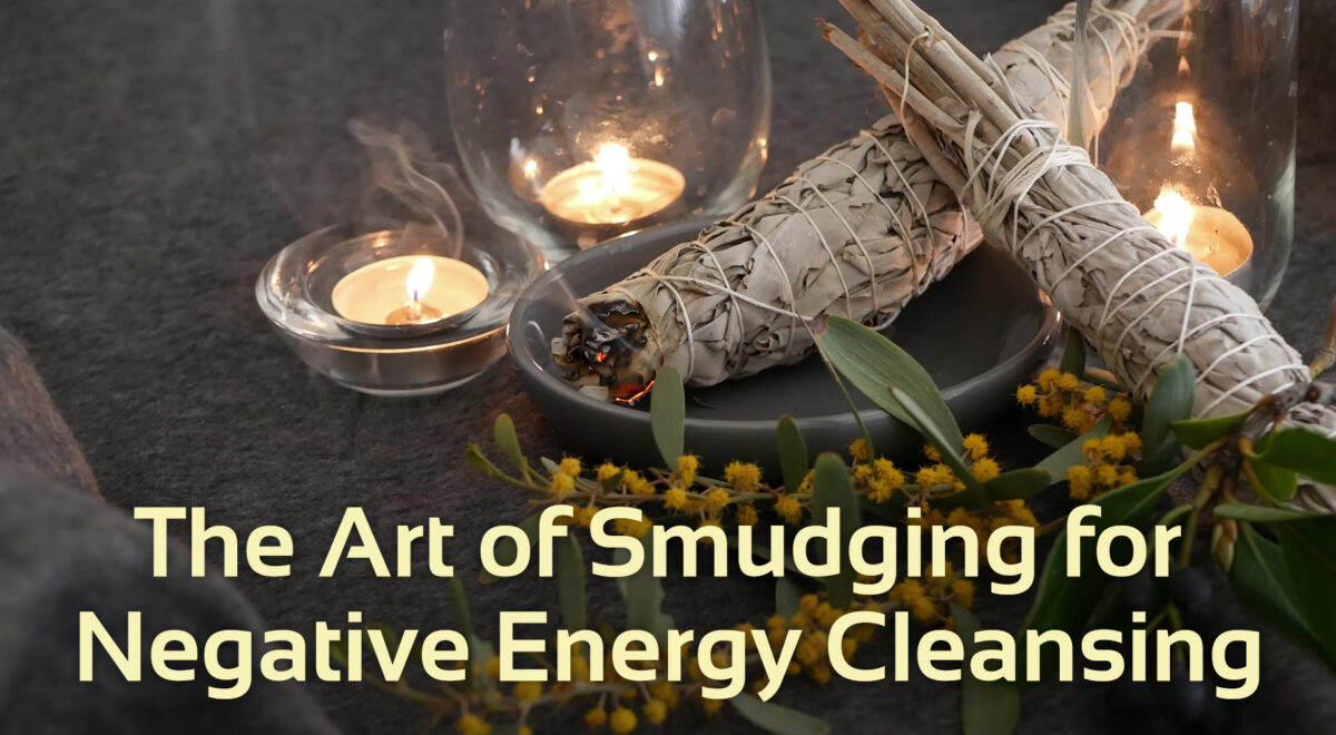 image showing sage bundle with candles in the background and flowers in the foreground; preparation for smudging sage burning negative energy cleansing ceremony
