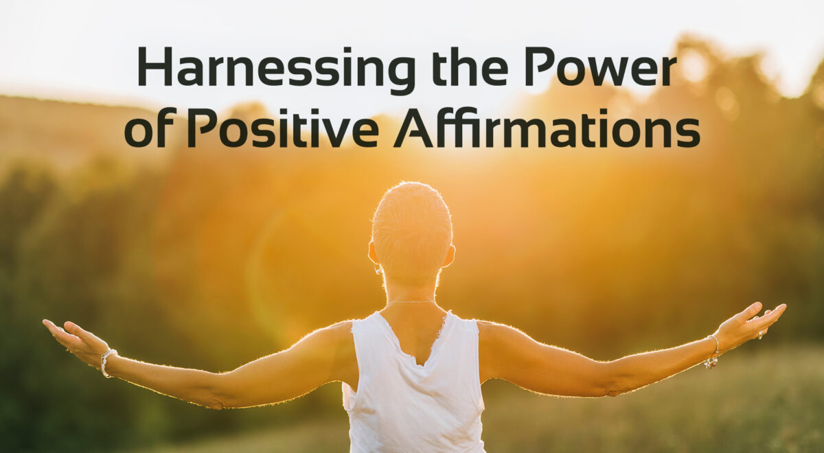 'harnessing the power of positive affirmations' text with image of person with open arms at sun set