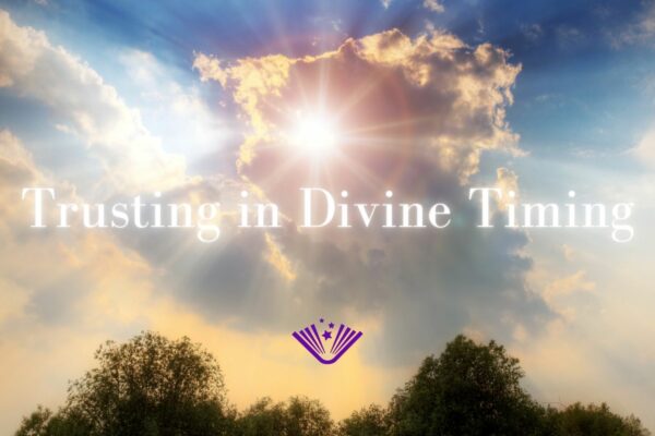 Trusting in Divine Timing text with background image of sun beams coming down over trees