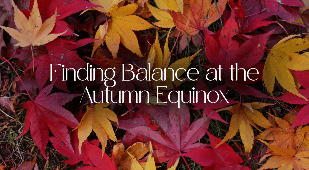 Finding Balance at the Autumn Equinox text with background image of autumn leaves