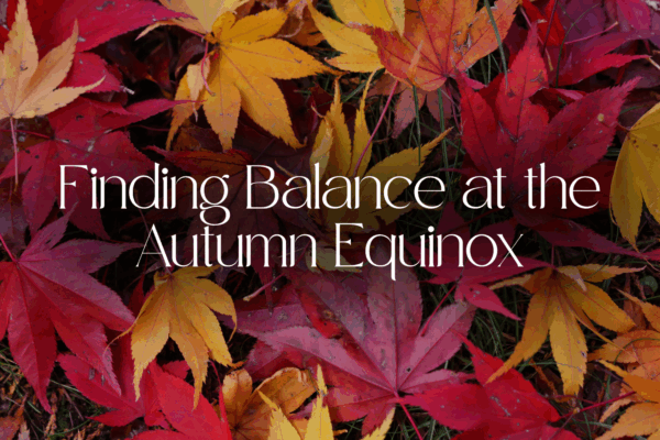 Finding Balance at the Autumn Equinox text with background image of autumn leaves